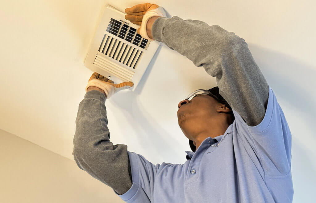 man cleaning air duct